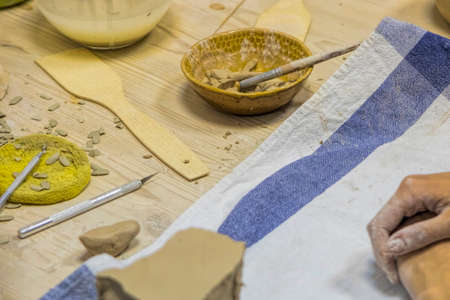 Wooden table of a sculptor. Tired hands. の写真素材