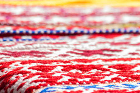 Colourful fabric with embroidered ornament on a counterの写真素材