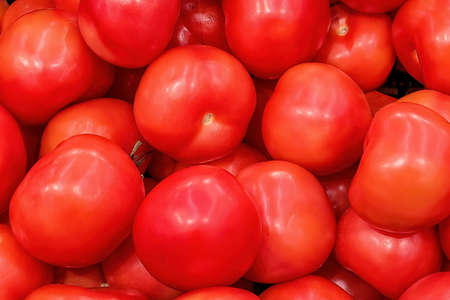 Fresh pink tomatos on a market counter