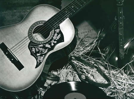 guitar, record, saddle in country backgroundの写真素材