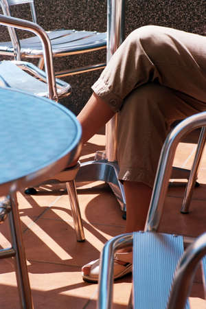 woman sitting at a street table の写真素材