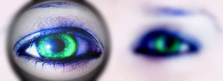 thick distorted  lens over one green eyeの写真素材