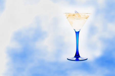 blue glass with drink and ice cubesの写真素材
