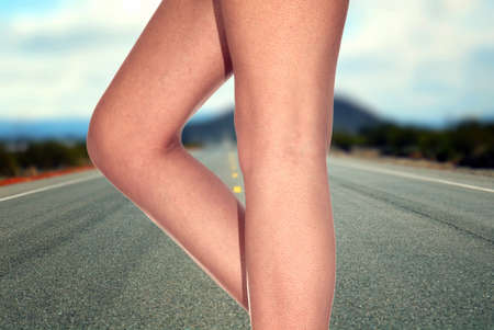 woman legs on the middle of the roadの写真素材