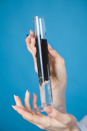 beautiful woman doctor in protective mask against coronavirus on a blue background in the Studioの写真素材