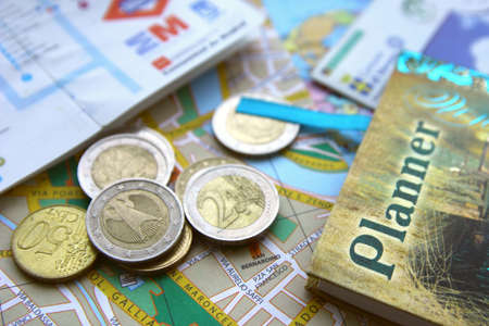 City maps, euro coins and planner