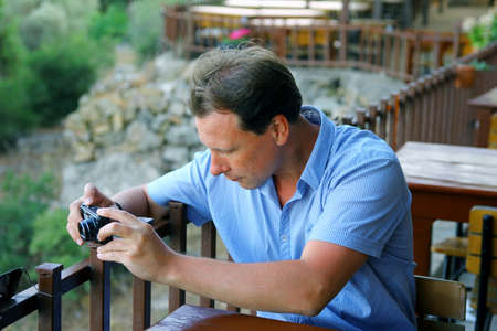 Man in the restaurant with cameraの写真素材