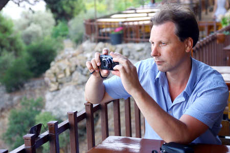 Man in the restaurant with cameraの写真素材