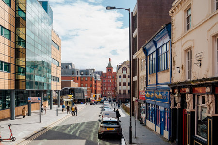 Liverpool, UK, April 11 2024: A sunny day on the street near Moorfields railway station. At the end of the street you can see the historic brick building known as the Prudential Assurance Buildingsのeditorial素材