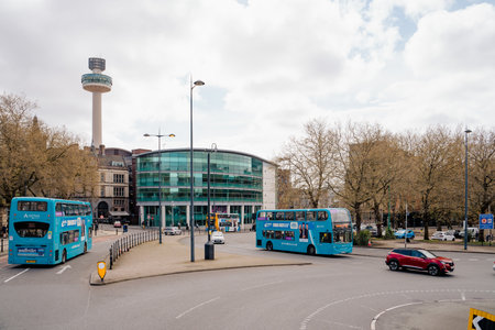 Liverpool, UK, April 11 2024: Radio City tower, seen from the side of the Torus building where the Liverpool City Observatory is also located. Blue buses pass through the intersection.のeditorial素材