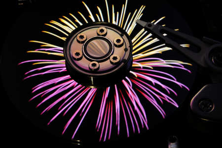 Close up of Computer Hard Disc Drives with color fireworks effects reflected on the disk surface....