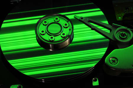 Close up of Computer Hard Drive Disc with abstract colors reflected on the disk surface. Background wallpaper.の写真素材