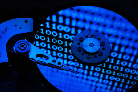 Close up of Computer Hard Drive Disc with abstract colors reflected on the disk surface. Background...