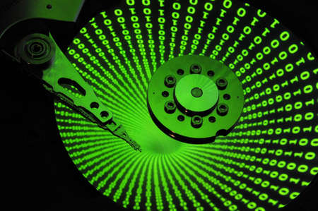 Close up of Computer Hard Drive Disc with abstract colors reflected on the disk surface. Background...
