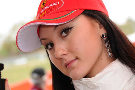 MUGELLO, IT, November, 2011: Unidentified Pit Babe poses for photos in the paddock During Ferrari World Finals 2011 at the Mugello Circuit in Italyのeditorial素材