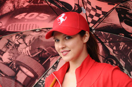 MUGELLO, IT, November, 2011: Unidentified Pit Babe poses for photos in the paddock During Ferrari World Finals 2011 at the Mugello Circuit in Italyのeditorial素材