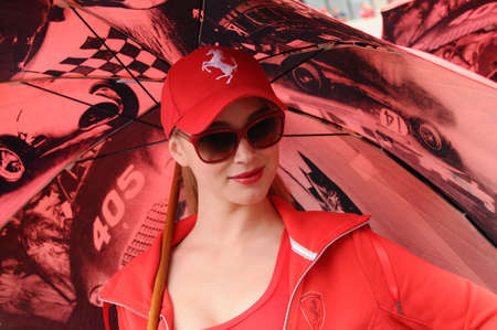 MUGELLO, IT, November, 2011: Unidentified Pit Babe poses for photos in the paddock During Ferrari World Finals 2011 at the Mugello Circuit in Italyのeditorial素材
