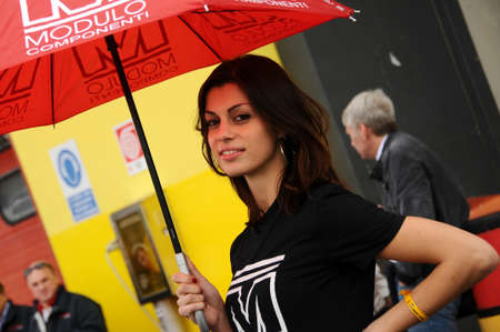 MUGELLO, IT, November, 2011: Unidentified Pit Babe poses for photos in the paddock During Ferrari World Finals 2011 at the Mugello Circuit in Italyのeditorial素材