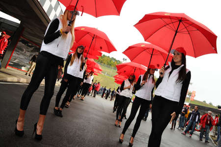MUGELLO, IT, November, 2011: Unidentified Pit Babe poses for photos in the paddock During Ferrari World Finals 2011 at the Mugello Circuit in Italyのeditorial素材