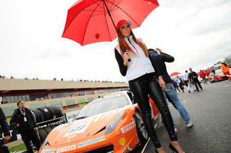 MUGELLO, IT, November, 2011: Unidentified Pit Babe poses for photos in the paddock During Ferrari World Finals 2011 at the Mugello Circuit in Italyのeditorial素材