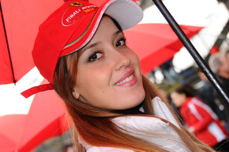 MUGELLO, IT, November, 2011: Unidentified Pit Babe poses for photos in the paddock During Ferrari World Finals 2011 at the Mugello Circuit in Italyのeditorial素材