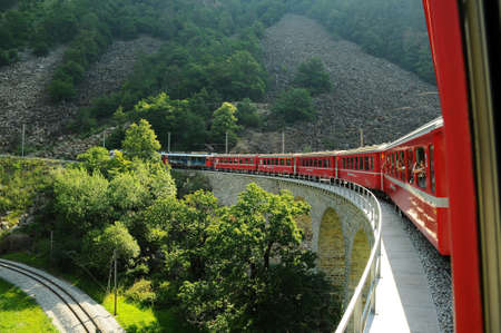 Swiss Red Train Bernina Express at Buzz Viaduct, Italy & Switzerlandのeditorial素材