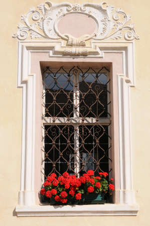 Window with geraniums in Trentino Alto Adige, Italy