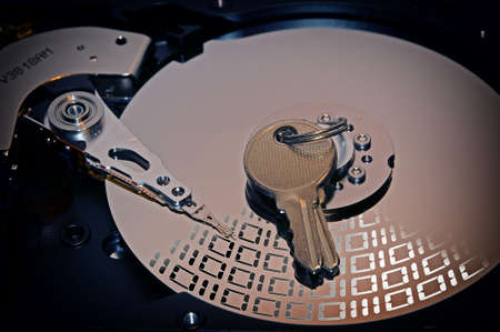 Close up of hard disk drive with padlock over. Concept of security.の写真素材