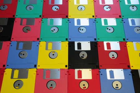 Multicolored floppy disk 3.5 for old computers. Aligned as background.の写真素材