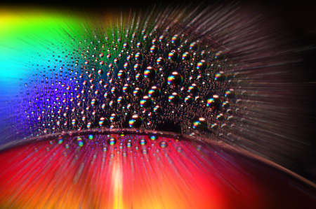 DVD and CD disc with water drops over and colorful effectsの写真素材