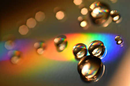 Water Drops on CD and DVD. Colorful background.の写真素材