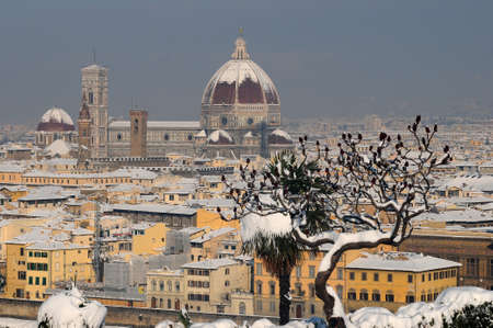 cathedral Santa Maria del Fiore (Duomo) and Giottos bell tower (campanile) in winter with snow Florence, Tuscany, Italyの写真素材