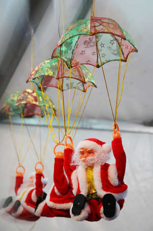 Santa Toys hangs from the roof in a Christmas marketの写真素材