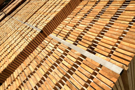 Stack of new wooden boards. Wooden plates on piles