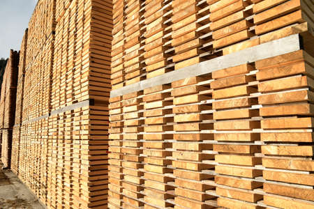 Stack of new wooden boards. Wooden plates on piles