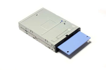 old computer floppy diskette inside floppy drive isolated on white background