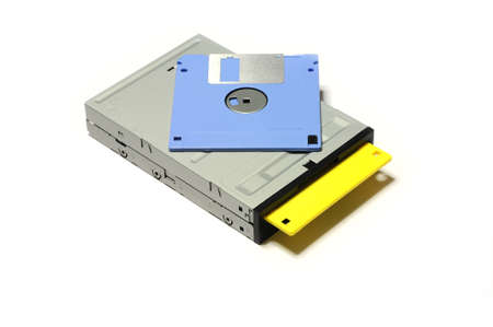 old computer floppy diskette inside floppy drive isolated on white background