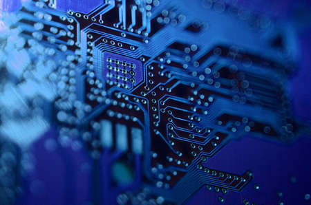 close-up of electronic circuit. electronic boards with blue light effects