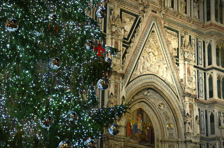 Illuminated Christmas tree with Santa Maria del Fiore on the background in Florence, Italy.の写真素材