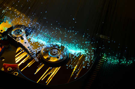 hard disk with colored fiber optics, tech background.の写真素材