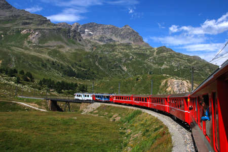 Switzerland: July 2012, Famous red alpine train Bernina Express (from St.Moritz to Tirano) near Bernina Pass (Switzerland)のeditorial素材