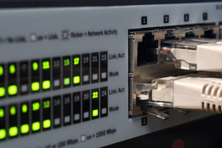 Detail of RJ45 Lan Cables and lights on network switches. Macro Shot