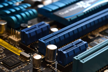 Electronics Components on a Modern PC Computer Motherboard with PCI-Express slot.