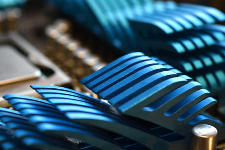 Detail of a blue aluminum heatsink on a modern pc motherboard. selective focus.