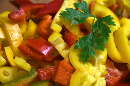 close up on cut yellow and red peppers ready to be cooked