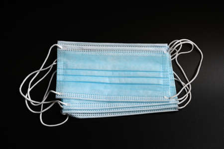 antiviral medical mask for protection against coronavirus. Surgical protective mask on black...