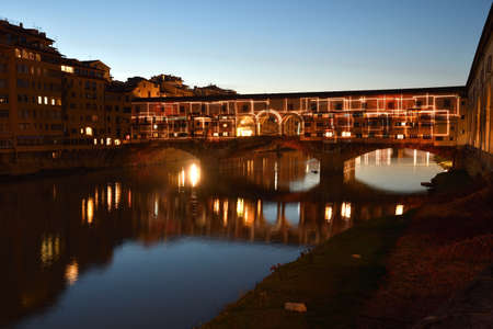 Florence - December 2020: The Famous Old Bridge over Arno river, illuminated on the occasion of Firenze Light Festival. Italy.のeditorial素材
