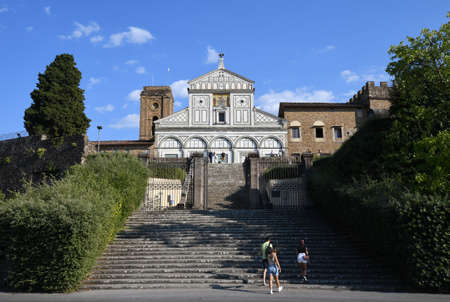 Florence, September 2021: Tourists on the step in front of the facade of the famous Basilica of San Miniato in Florence.のeditorial素材