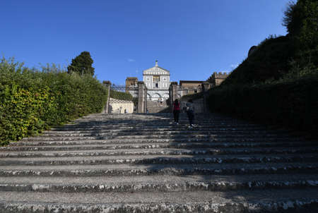 Florence, September 2021: Tourists on the step in front of the facade of the famous Basilica of San Miniato in Florence.のeditorial素材