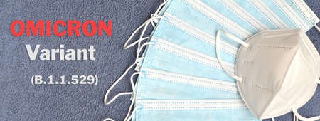 Covid-19 Omicron variant. Text "Covid-19 Omicron Variant" with many protection masks. Concept of protection from the new Omicron variant.の写真素材